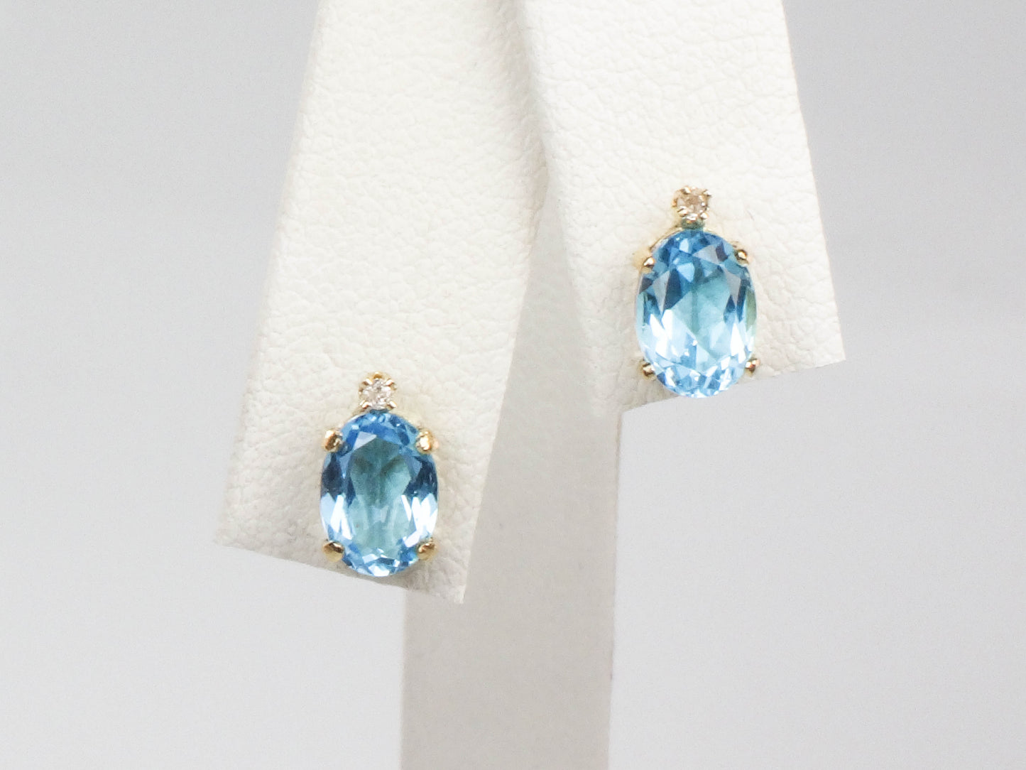 Pre-Owned 14k Yellow Gold Blue Topaz Stud Earrings with White Sapphire Accents, Oval December Birthstone Studs