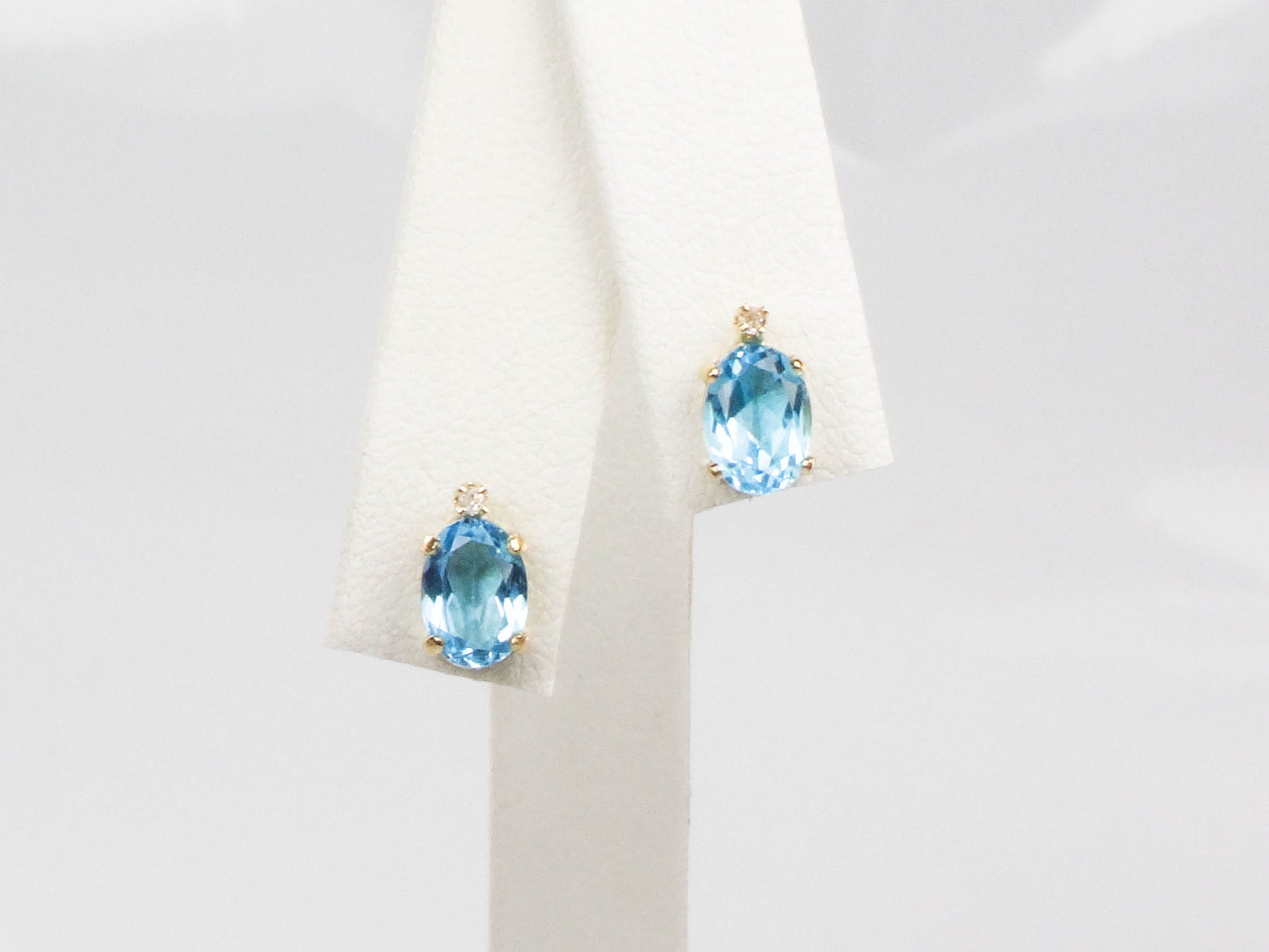 Pre-Owned 14k Yellow Gold Blue Topaz Stud Earrings with White Sapphire Accents, Oval December Birthstone Studs