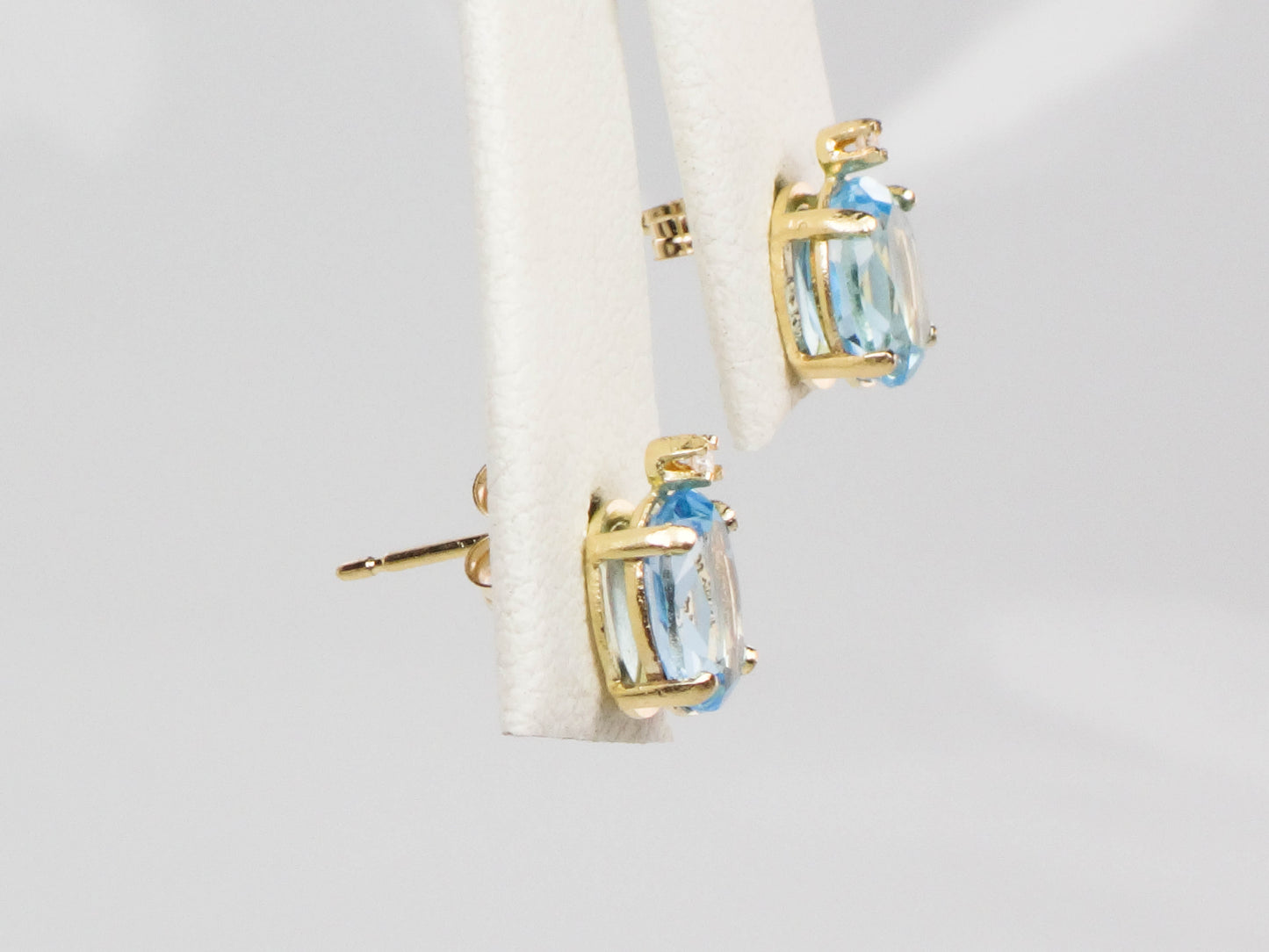 Pre-Owned 14k Yellow Gold Blue Topaz Stud Earrings with White Sapphire Accents, Oval December Birthstone Studs