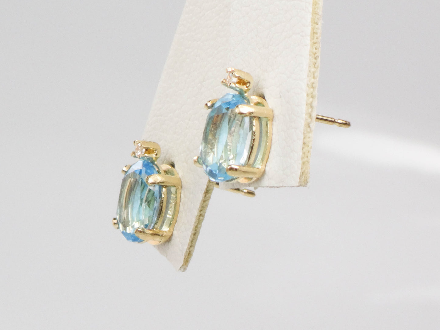 Pre-Owned 14k Yellow Gold Blue Topaz Stud Earrings with White Sapphire Accents, Oval December Birthstone Studs