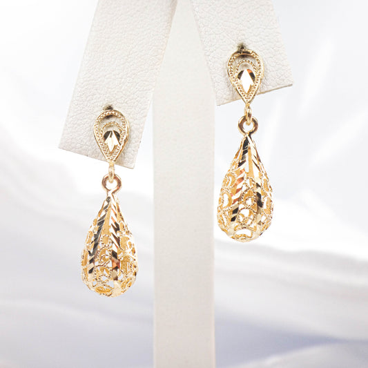 Gold teardrop earrings on a white background