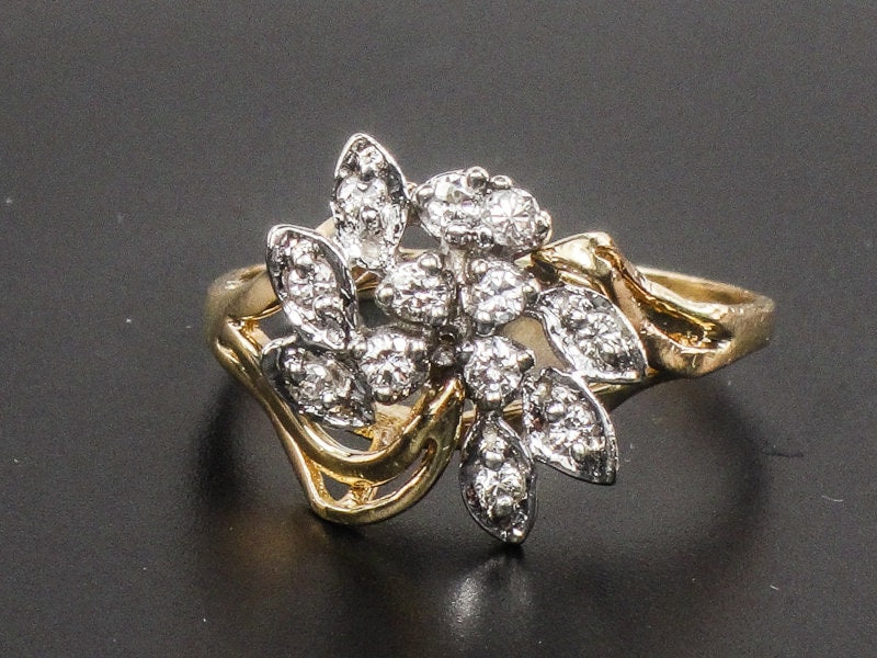 Vintage 14k Two Tone Gold Diamond Cluster Everyday Ring Size 8.25. A gold ring with a floral design set with small diamonds. The ring is made of yellow gold and has a delicate, intricate design.