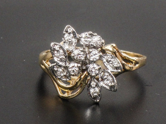 Vintage 14k Two Tone Gold Diamond Cluster Everyday Ring Size 8.25. A gold ring with a floral design set with small diamonds. The ring is made of yellow gold and has a delicate, intricate design.