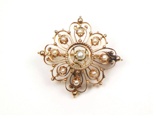 Vintage Victorian 14k Yellow Gold Pearl Pendant Pin, Antique June Birthstone Pendant. A gold and pearl brooch. The brooch is made of delicate filigree work and features eight small pearls around the outer edge and a larger pearl in the center.