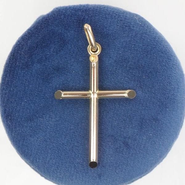 A vintage gold cross pendant with a simple design. Unisex 14k Gold Cross.